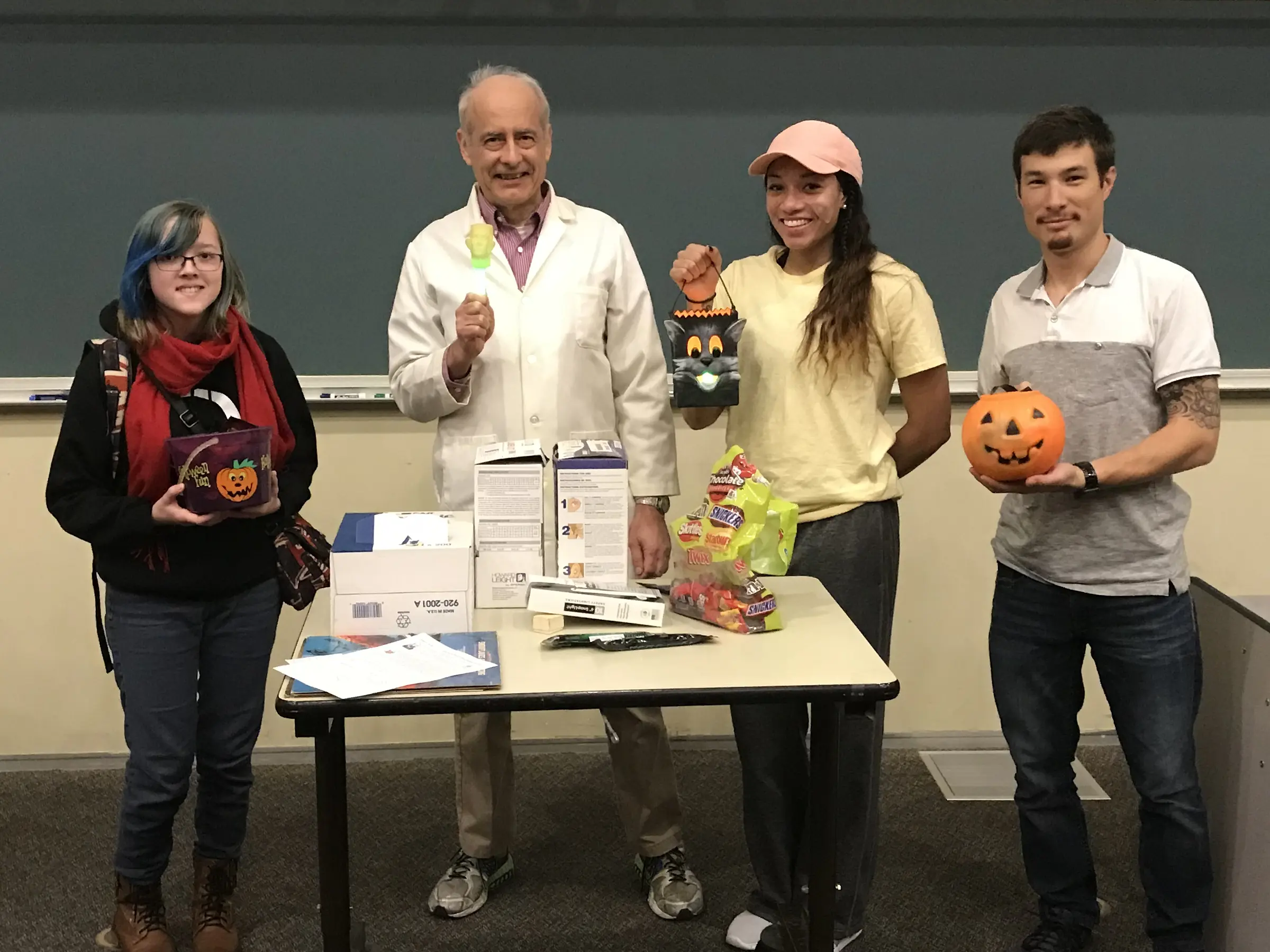 Doc and 3 students with Halloween candy.